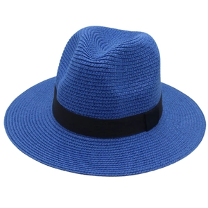 Detail of blue Panama straw hat showing fine weave texture and black ribbon band