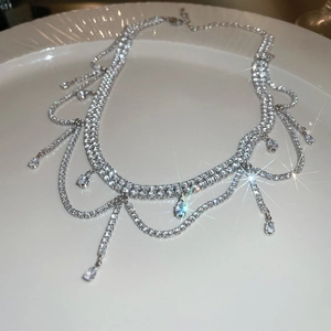 Detailed close-up of a silver diamond tassel necklace with elegant water drop pendants