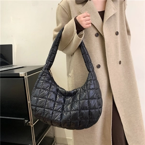 Women's black quilted puffer shoulder bag with a soft dumpling shape for casual winter style