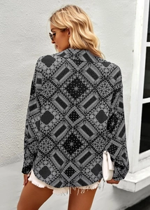 Rear view of black long-sleeved shirt with white paisley print and elegant commuter style
