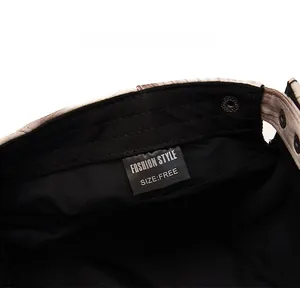 Detail view of cotton newsboy hat interior showing black wash label and metal rivet