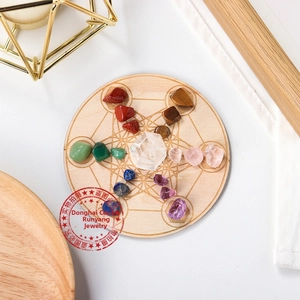Macro shot of colorful natural crystal chakra stones on a geometric wooden tray