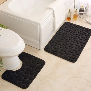 Detail view of 2-piece black memory foam bath mat set with embossed pebble texture