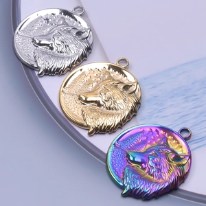 Detail view of round stainless steel wolf head pendants in silver gold and rainbow finishes