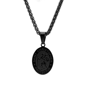 Macro detail of black Saint Christopher pendant with protective religious engraving
