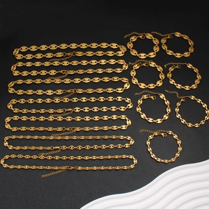 Detailed grid of gold coffee bean link necklaces and bracelets on black background