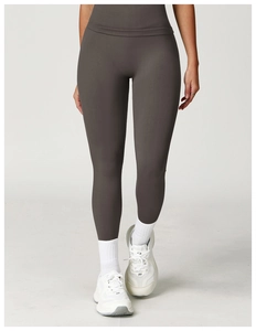 Close-up of high-waisted seamless yoga leggings in charcoal grey with athletic shoes