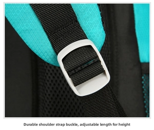 Detail of adjustable shoulder strap with durable buckle on a green hiking backpack