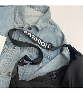 Detail of adjustable black strap with white FASHION lettering and double zippers