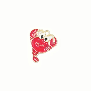Detailed view of a cute red cartoon lobster brooch with elegant golden metal edging