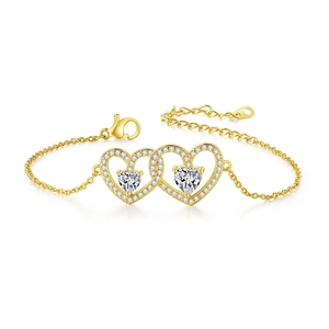 Detailed view of gold bracelet featuring interlocking hollow hearts with pavé zircon stones