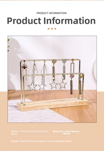 Detail view of double-layer gold metal earring stand with light natural wood base