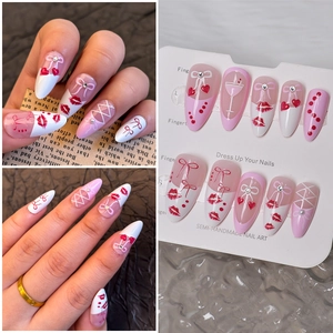Detail of semi-handmade press-on nails with pink bows, hearts, and rhinestone accents