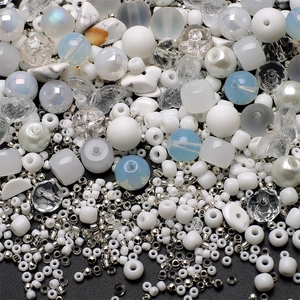 Macro shot of 8mm mixed glass beads with butterfly charms and gradient blue seed beads