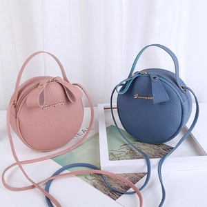 Pink and blue round mini crossbody bags in lychee leather with gold logo