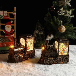 Detail of vintage bronze Christmas train music box with Santa and glowing snow globe