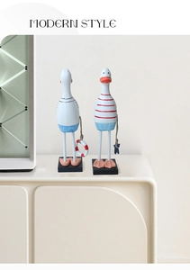 Detail showing two Mediterranean style nautical ducks on black bases with striped patterns