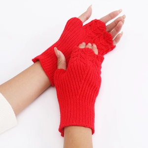 Detail showing red knitted fingerless gloves with intricate hollow crochet fish scale pattern