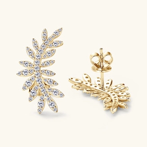 Detail of golden leaf earrings featuring micro-pave clear cubic zirconia stones