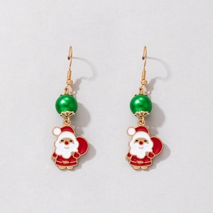 Macro detail of Christmas Santa Claus drop earrings with green beads and enamel finish