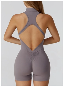 Detailed back view of open-back yoga jumpsuit with ruched seam and smoky purple fabric