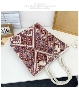 Detail of canvas tote bag showing ethnic embroidery pattern and cotton rope handle