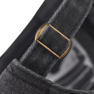 Close-up of the vintage bronze metal buckle and grey felt strap on the baseball cap