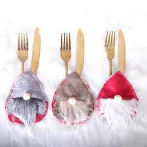 Three faceless gnome Christmas cutlery holders in grey, brown and red non-woven fabric