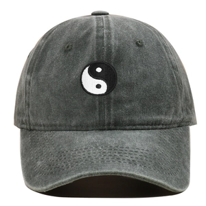 Macro detail of Tai Chi embroidery on dark gray washed vintage style cotton baseball cap