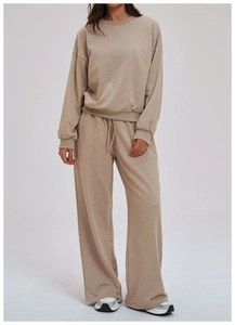 Detail of khaki crewneck sweatshirt and drawstring wide-leg pants fabric texture