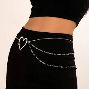 Detail of silver multilayer body chain featuring a hollow heart buckle on female waist
