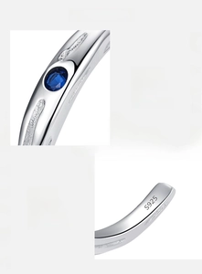 Detailed macro view showing the S925 hallmark and blue zircon inlay on the silver ring