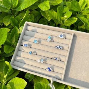 Collection of S925 silver rings with blue heart and geometric zircons in a gray jewelry box