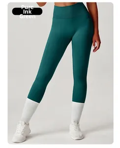 Detail of high waisted dark green yoga pants with side pockets and slimming tummy control