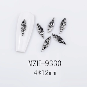 Macro detail of leaf shaped retro silver nail charms showing 4x12mm size and textures