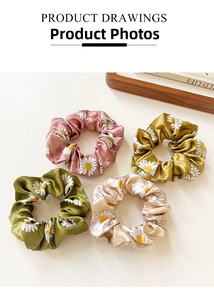 Detailed set of four daisy patterned satin scrunchies in pink, yellow, green and champagne