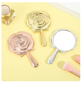 Detailed view of rose-shaped handheld mirrors in gold, rose gold, and silver finishes