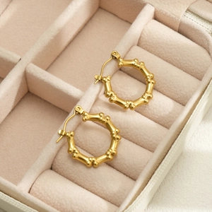 18k gold plated stainless steel bamboo textured hoop earrings on a velvet jewelry box