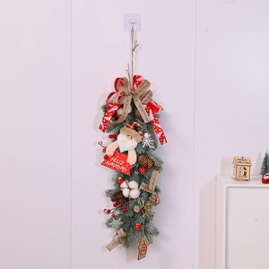 Detailed Christmas swag featuring Santa doll, pine cones, and Feliz Navidad sign