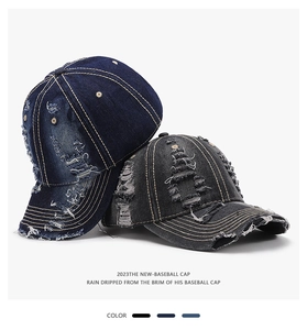 Detail of distressed denim baseball caps showing frayed holes and contrast stitching