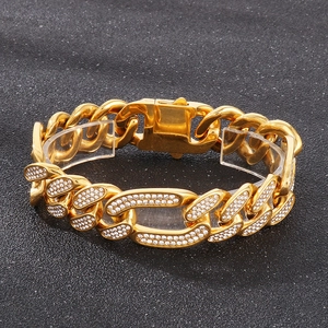Close-up of gold iced-out hip hop link bracelet with diamonds on acrylic stand