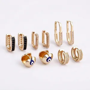 Golden heart earrings set with twisted patterns, sparkling crystals and evil eye charms