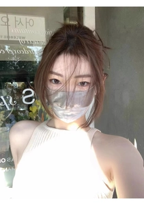 Close-up of a silver silk sun protection face mask with ear loops and eye corner coverage
