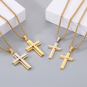 Detailed view of dual-layer cross pendants in gold and silver finish on round box chain