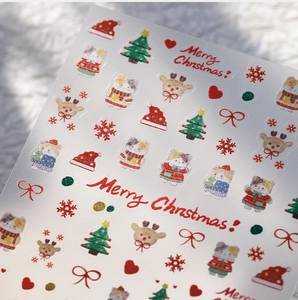 Macro shot of 5D embossed Christmas nail stickers with cat, elk and snowflake patterns