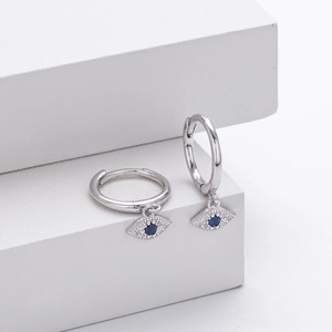 Detail of S925 silver Evil Eye drop earrings with blue zircon on white background