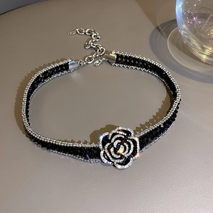 Elegant black crystal choker with a sparkling 3D rose pendant and silver diamond details