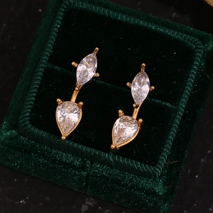 Close-up of 18K gold-plated drop zircon earrings in a premium green velvet box
