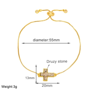 Detail of adjustable gold cross bracelet with druzy stone and sizing measurements