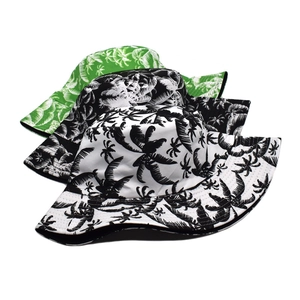 Detailed close-up of three tropical palm leaf print bucket hats in canvas material